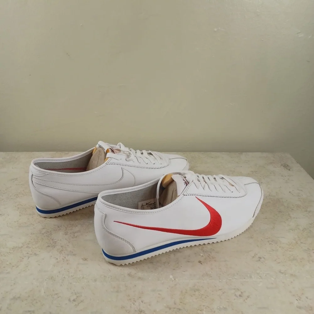Nike White Sneakers with Red Swoosh and Blue Outsole Trim